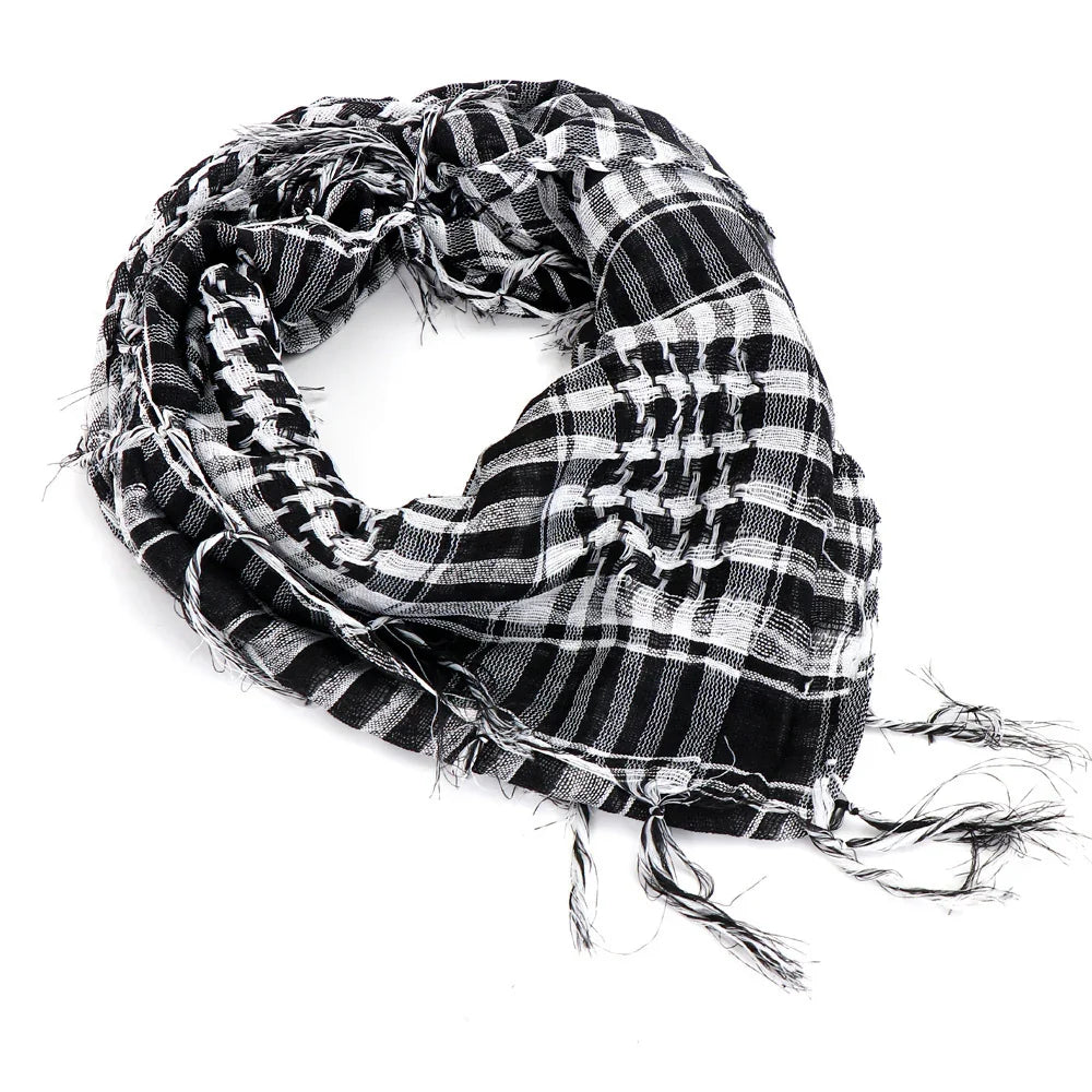 Black and white checkered keffiyeh scarf with fringed edges on white background