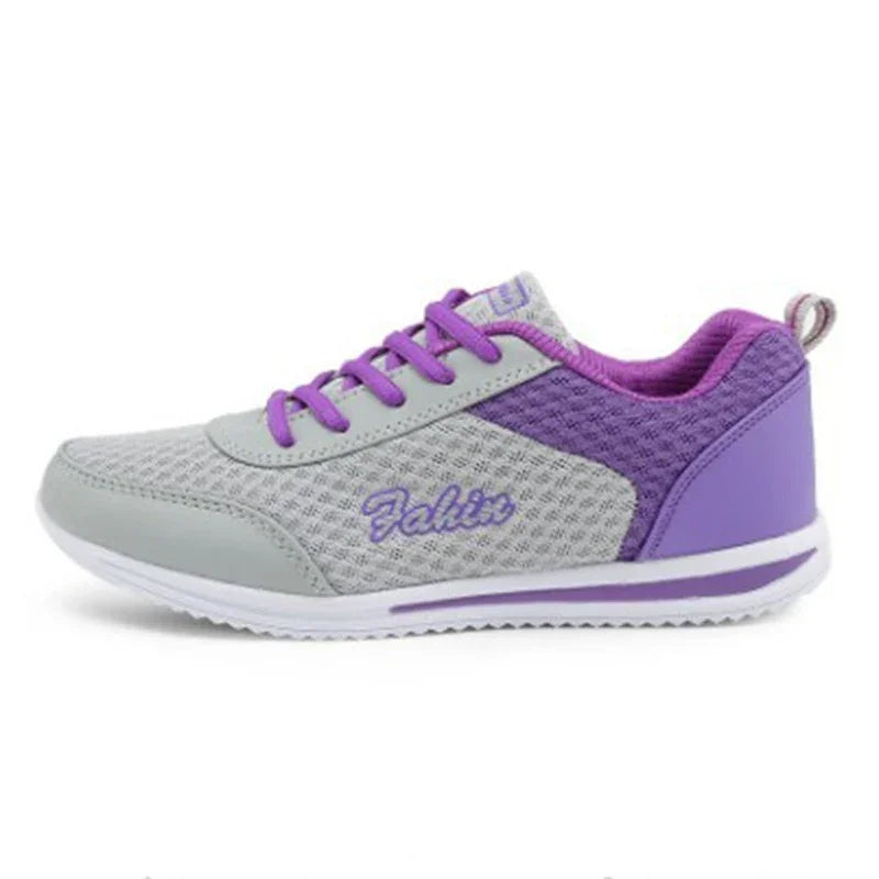 Gray and purple breathable athletic sneaker with purple laces and white sole, side view
