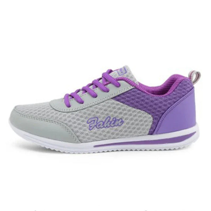 Gray and purple breathable athletic sneaker with purple laces and white sole, side view