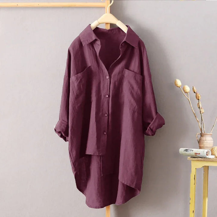 Casual oversized plum purple button-up linen shirt with rolled sleeves on wooden hanger