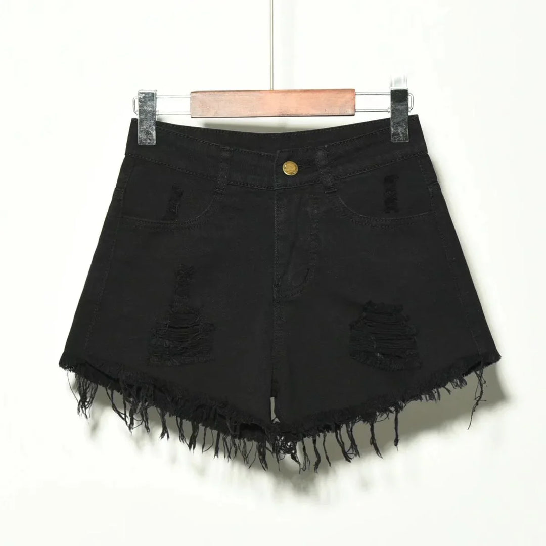 Black distressed denim shorts with frayed hem hanging on wooden hanger