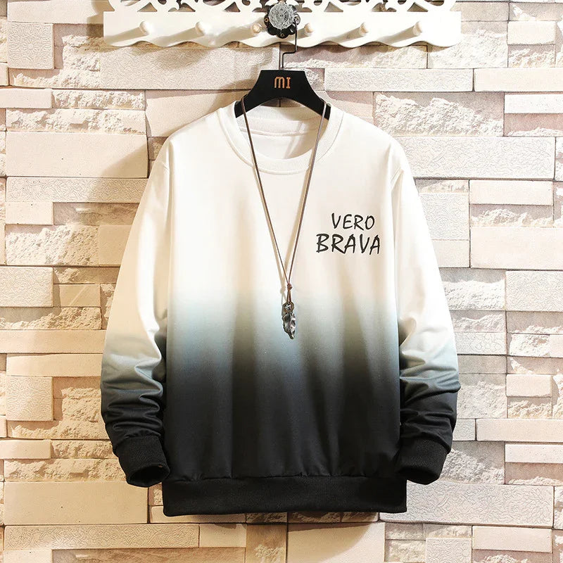 White and black gradient sweatshirt with VERO BRAVA text hanging on a black MI hanger against a stone wall background
