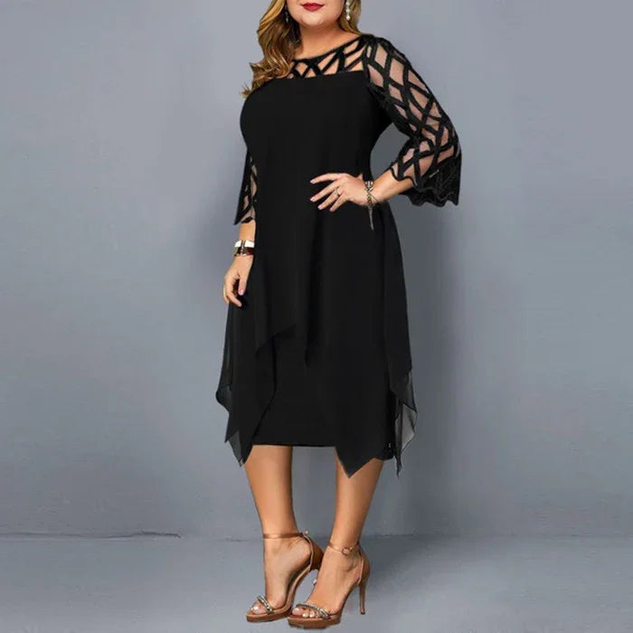 Plus size woman wearing elegant black dress with geometric mesh sleeves and layered hem, gold heels