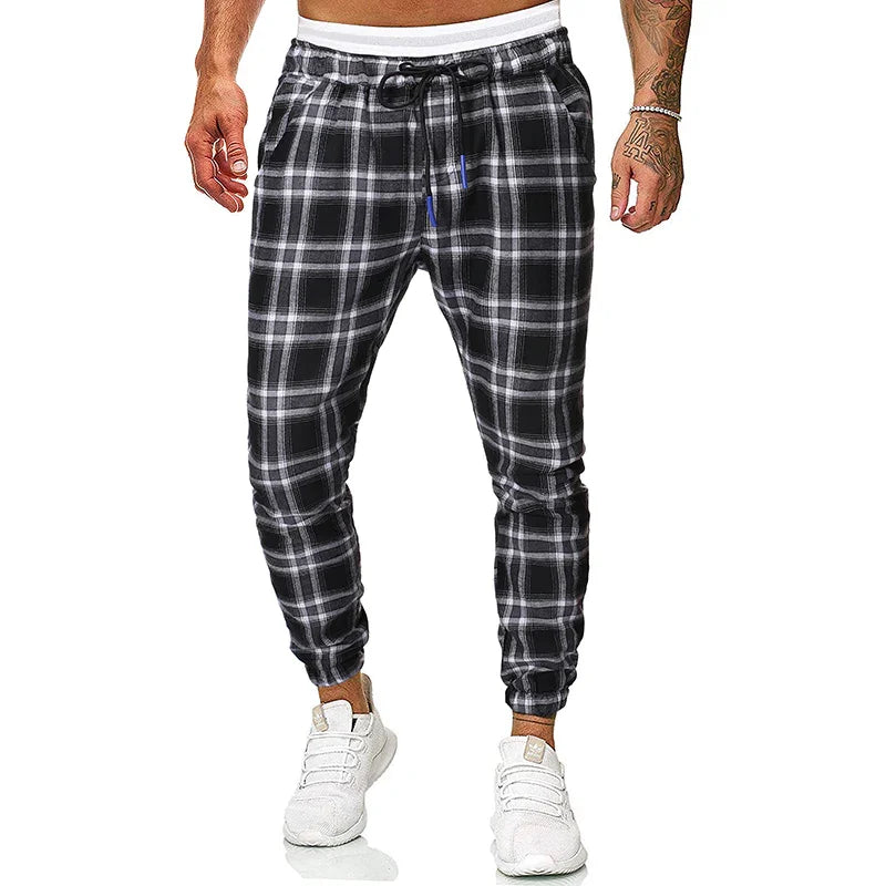 Men's black and white plaid jogger pants with elastic cuffs and drawstring waistband