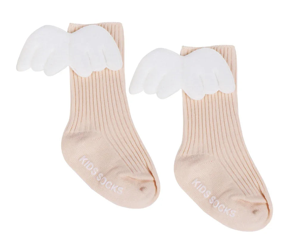 Beige ribbed kids socks with white angel wings attached, labeled 'KIDS SOCKS'