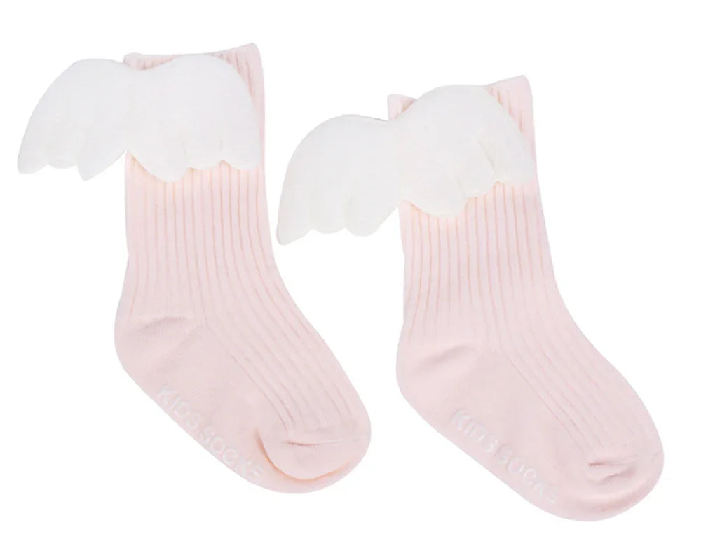 Pair of light pink ribbed kids socks with white angel wings attached on the sides