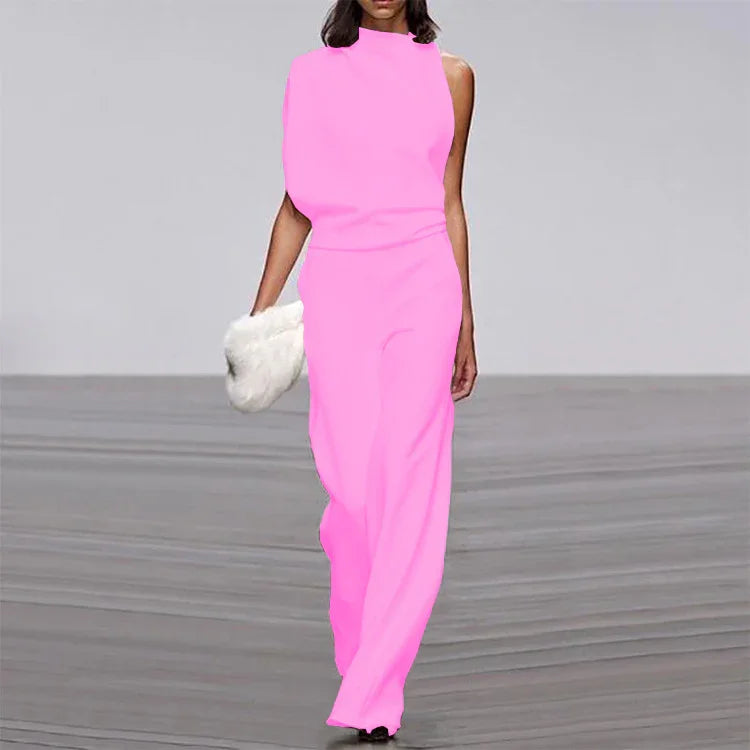 Model in pink sleeveless jumpsuit walking runway holding white fur handbag