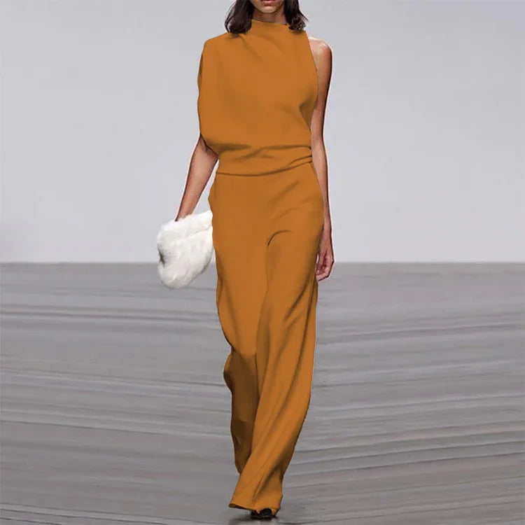 Fashion model walking runway in sleeveless orange jumpsuit holding white fur clutch