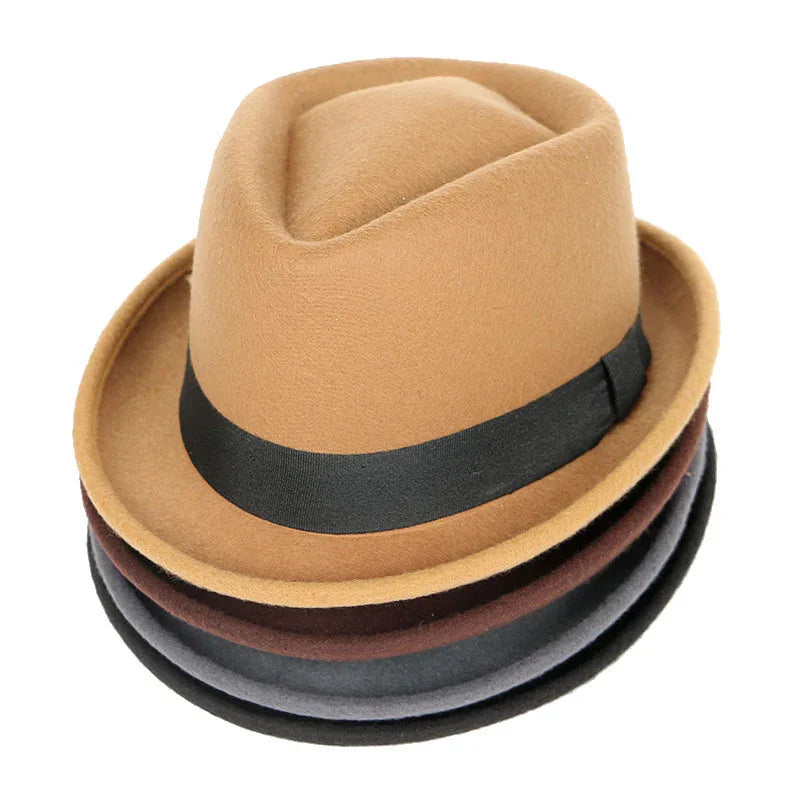Stack of classic fedora hats in camel, brown, gray, and black with black bands