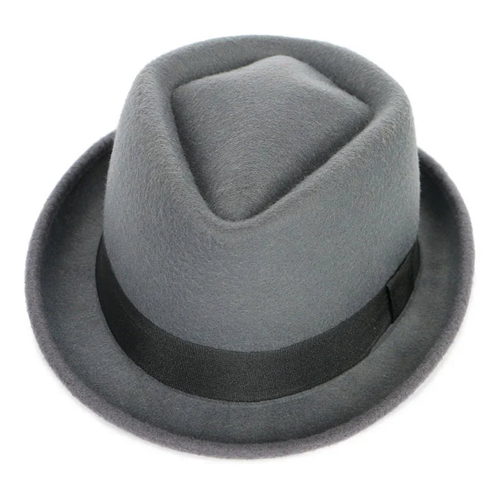 Gray felt fedora hat with black band and short curled brim on white background
