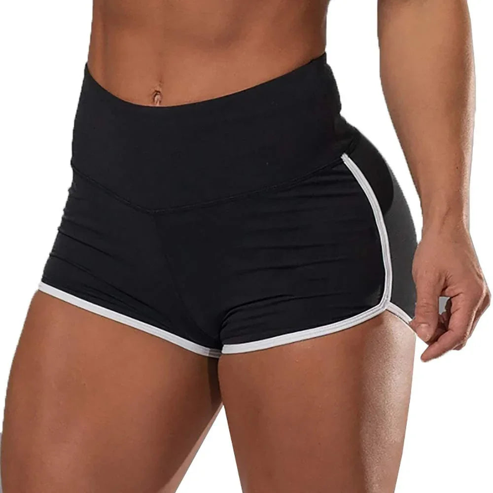 Close-up of athletic woman wearing black high-waisted workout shorts with white trim