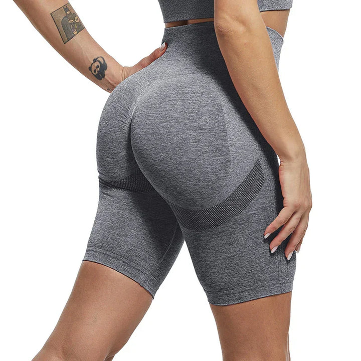 Woman wearing seamless grey high-waisted fitness shorts highlighting contour and butt lift design