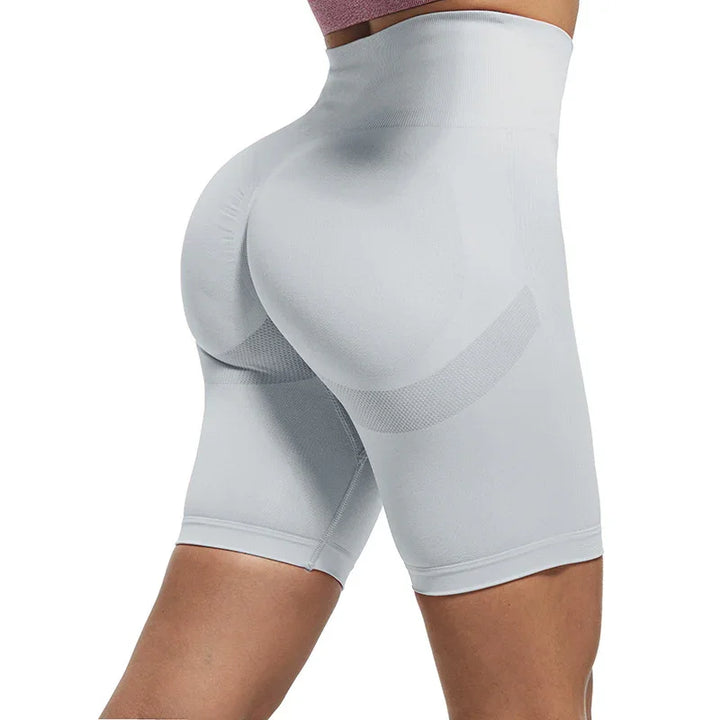 Close-up of woman wearing light grey seamless high-waisted shaping shorts enhancing curves