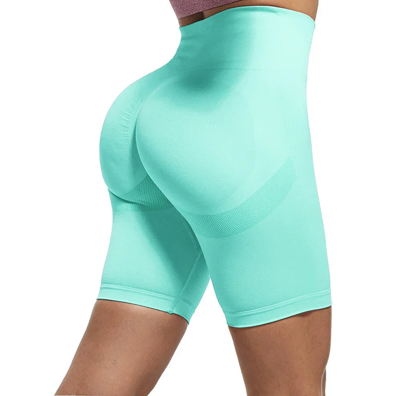 Woman wearing high-waisted turquoise seamless shapewear shorts with butt lifting design