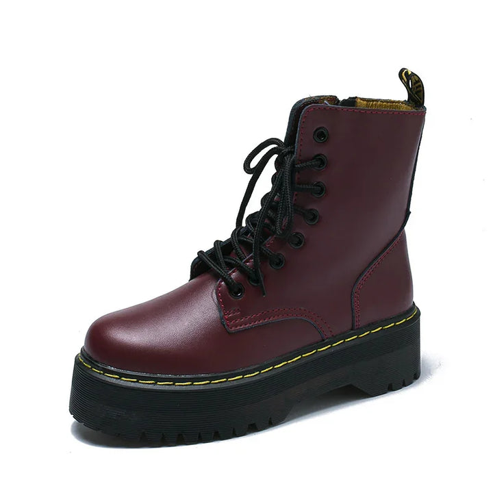 Burgundy leather platform combat boot with black laces and yellow stitching on thick sole