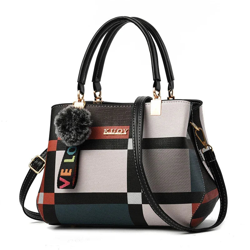 Stylish plaid handbag with black handles, pom-pom charm and 'KUOY' gold logo