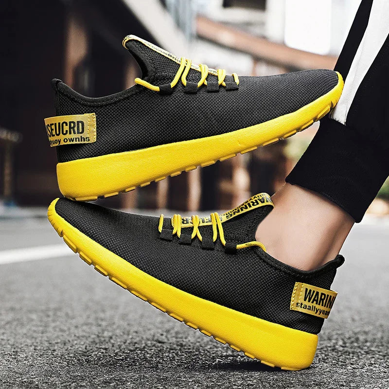 Black and yellow lightweight casual sneakers with yellow laces and text patches on the heel