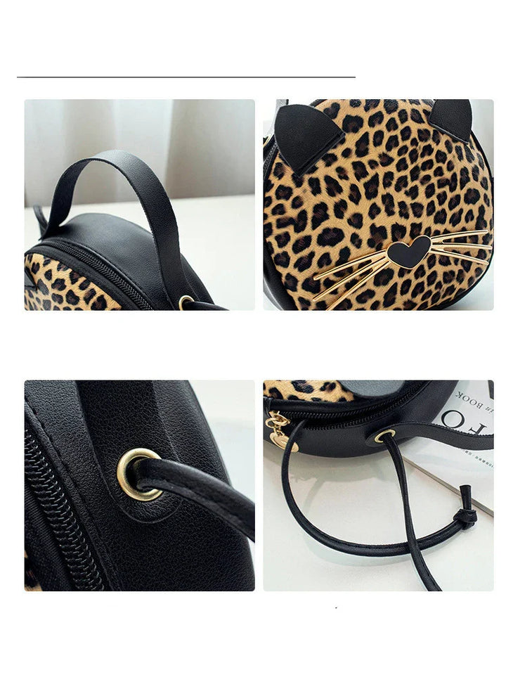 Round leopard print crossbody bag with black cat ears, gold whiskers, and black leather strap details