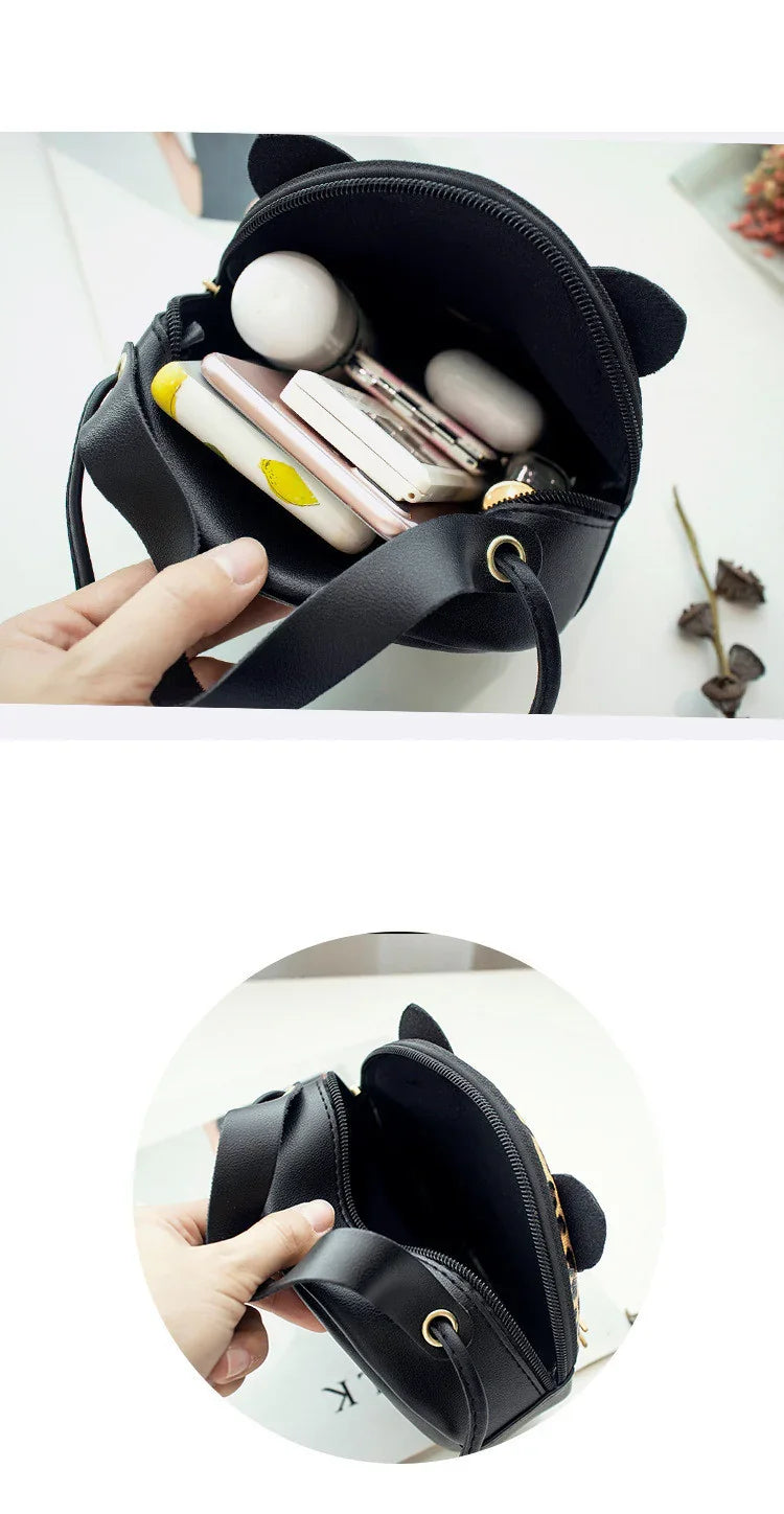 Small black leather crossbody bag with cat ears, shown open with items inside and empty