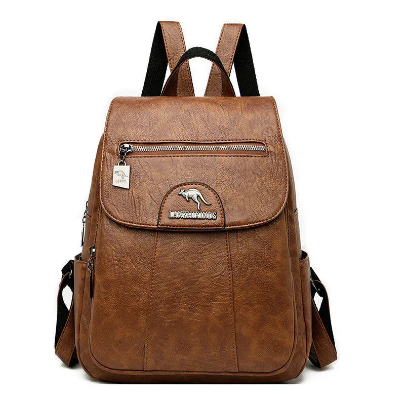Brown leather backpack with front zipper pocket and kangaroo logo on white background