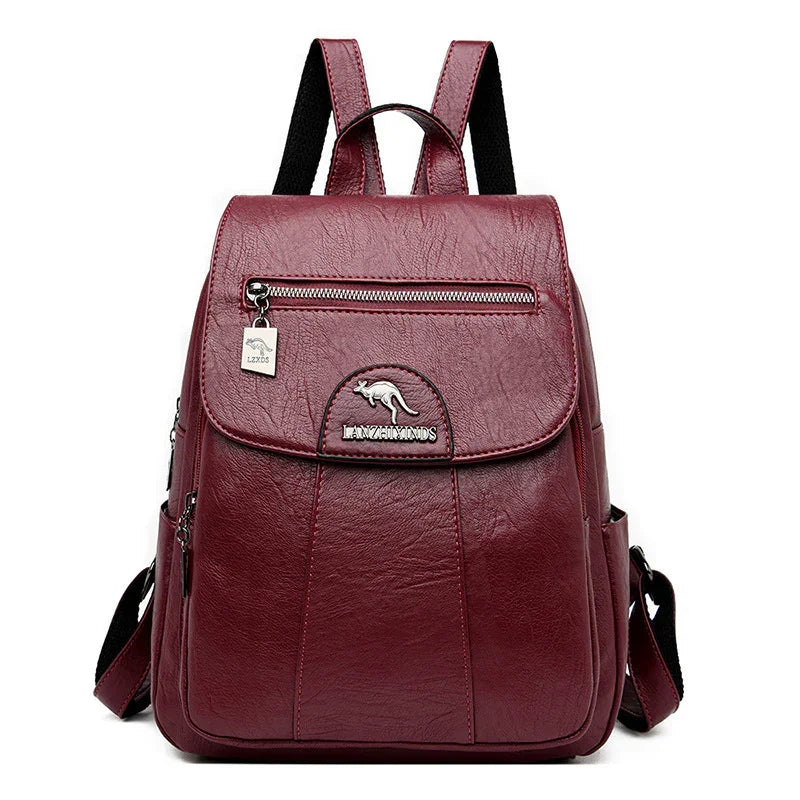 Burgundy leather backpack with front zipper pocket, kangaroo logo, and adjustable straps