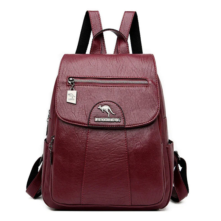 Burgundy leather backpack with front zipper pocket, kangaroo logo, and adjustable straps