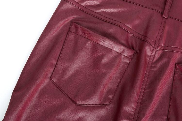 Close-up of burgundy faux leather pants with stitched back pockets