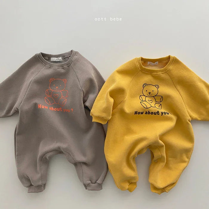 Two baby rompers in gray and yellow with teddy bear and "How about you?" text print