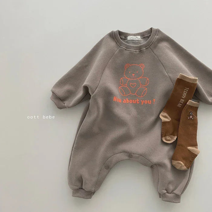 Gray baby onesie with orange teddy bear graphic and text "How about you?" paired with brown teddy bear socks