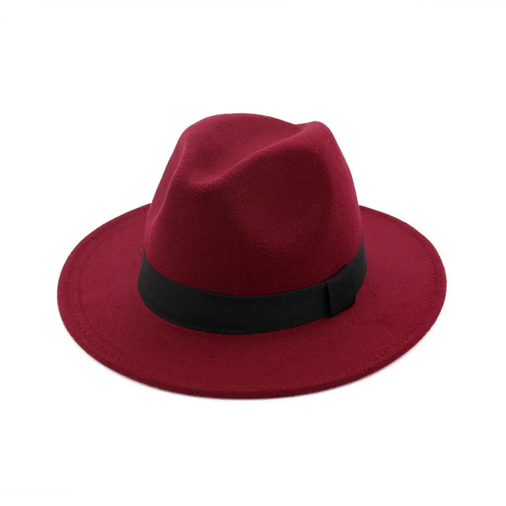 Red fedora hat with black band on white background, stylish men's fashion accessory