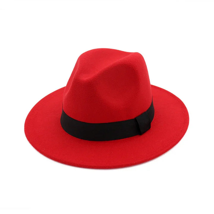 Red fedora hat with a black band on white background, stylish men's fashion accessory