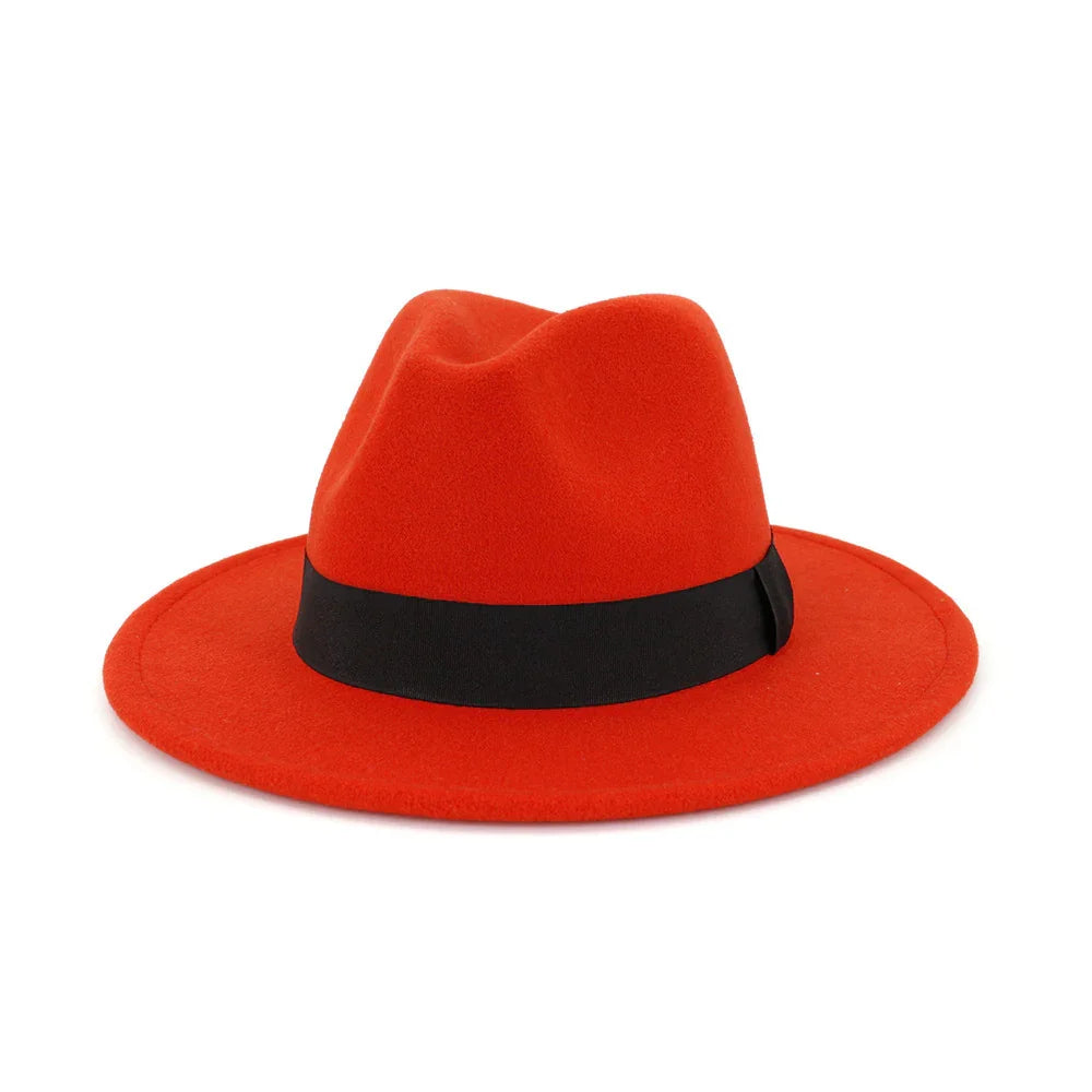 Red felt fedora hat with black band on white background