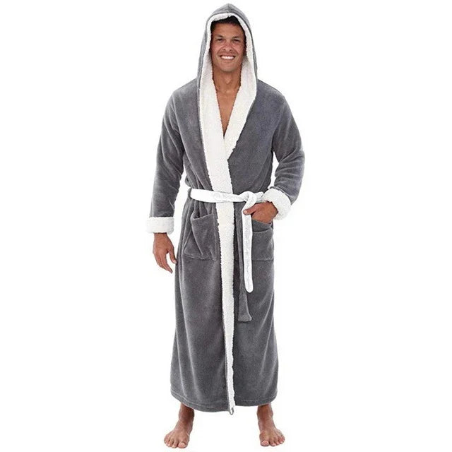 Man wearing gray hooded plush bathrobe with white trim and belt, standing barefoot on white background