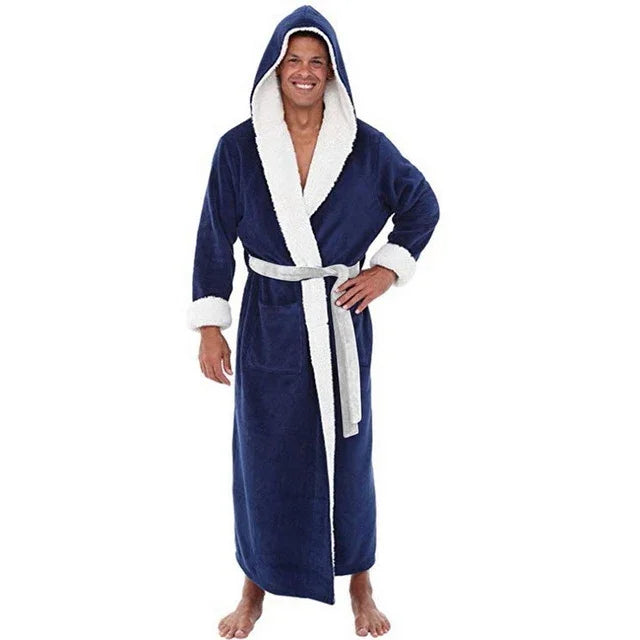 smiling man wearing long navy blue hooded bathrobe with white fleece trim and belt barefoot