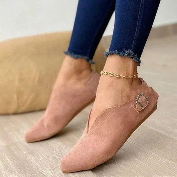 pink suede pointed toe slip-on flats with buckle detail worn with dark frayed hem leggings and gold anklet