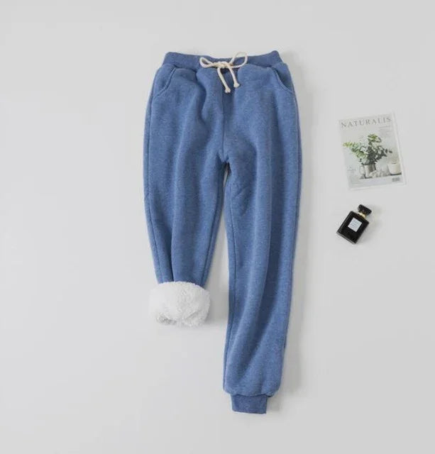 Blue fleece-lined jogger pants with drawstring and cuffed ankle on white background