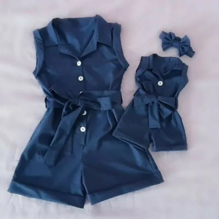 Matching navy blue sleeveless romper set with belt and white buttons for women and dolls with bow accessory