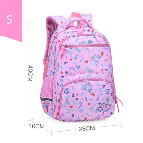 Pink kids backpack with colorful floral and butterfly patterns, multiple zippered compartments, and padded straps