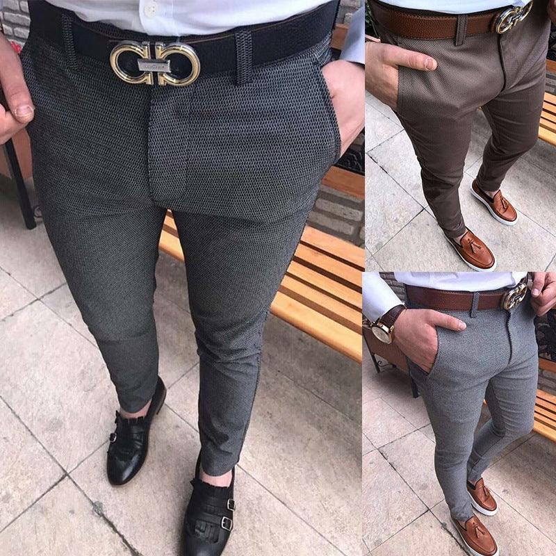 Men wearing stylish slim-fit dress pants in grey, brown, and light grey with leather belts and dress shoes