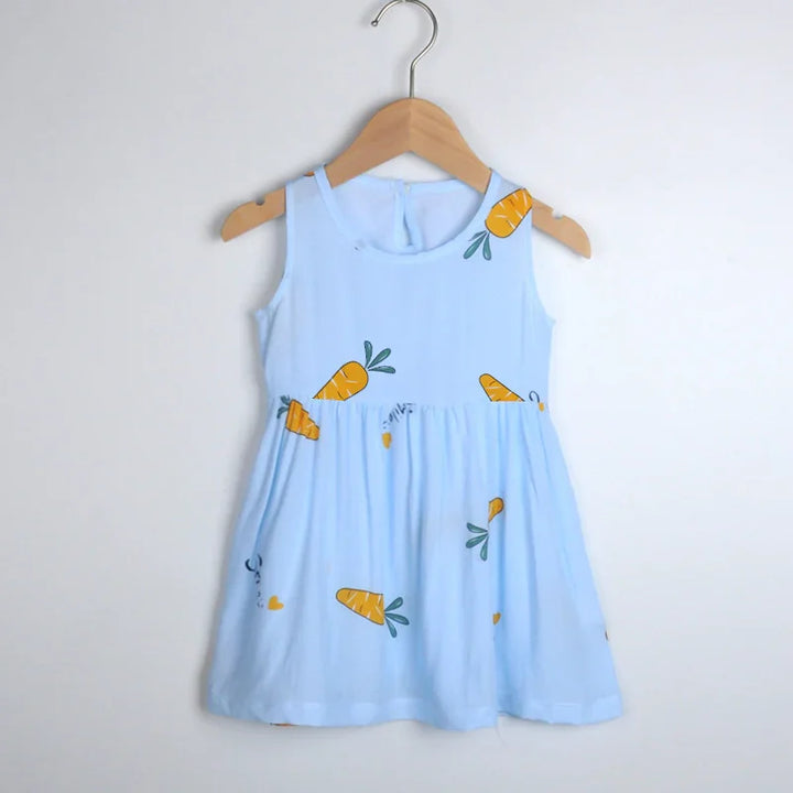 Light blue sleeveless baby dress with orange carrot prints on wooden hanger