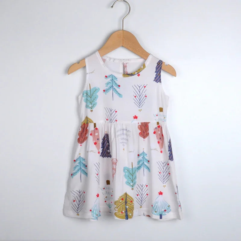 White sleeveless toddler dress with colorful Christmas tree print hanging on wooden hanger