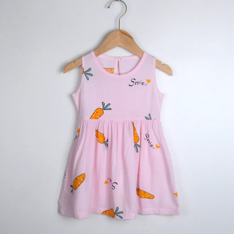 Pink sleeveless toddler dress with carrot prints and 'Smile' text hanging on wooden hanger