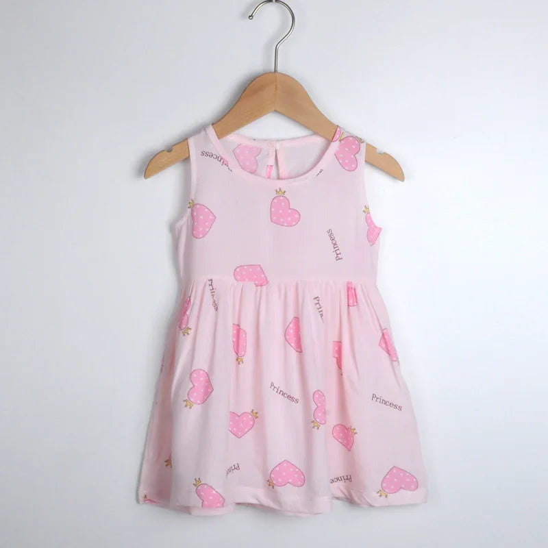 Pink sleeveless toddler dress with pink polka dot hearts and princess text on wooden hanger