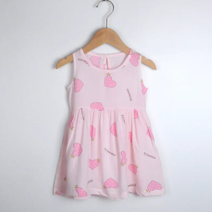 Pink sleeveless toddler dress with pink polka dot hearts and princess text on wooden hanger