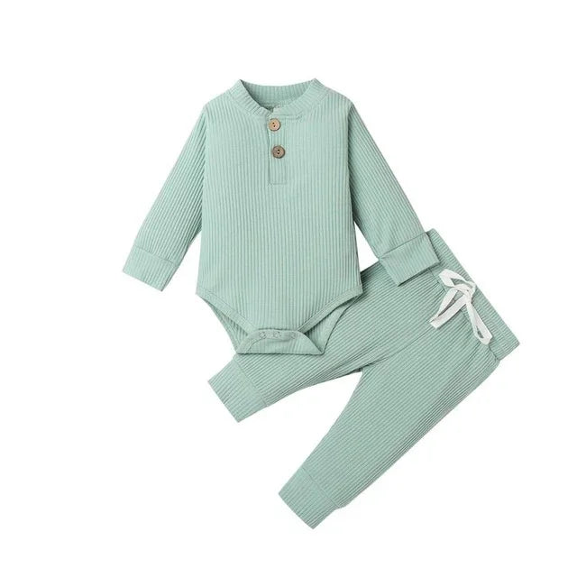 Light green ribbed long sleeve baby bodysuit with wooden button accents paired with matching pants featuring a white drawstring