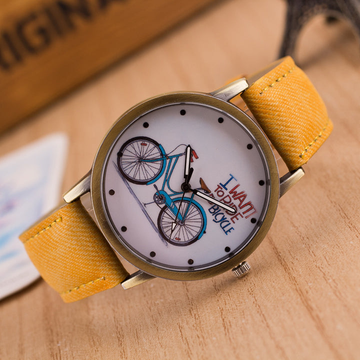 Yellow strap wristwatch with bicycle illustration and text I want to ride my bicycle on white dial