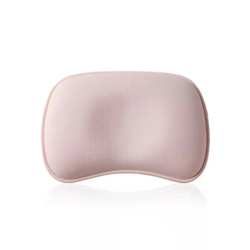 Soft pink curved memory foam neck pillow with textured cover on white background
