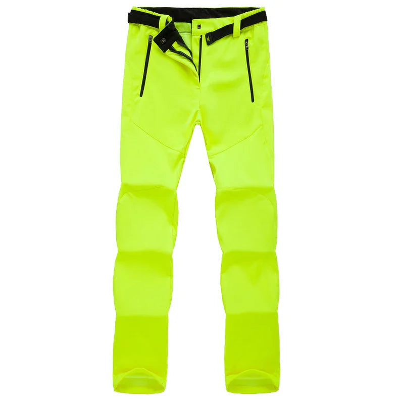 High-visibility neon yellow outdoor softshell pants with black zipper pockets and adjustable waist