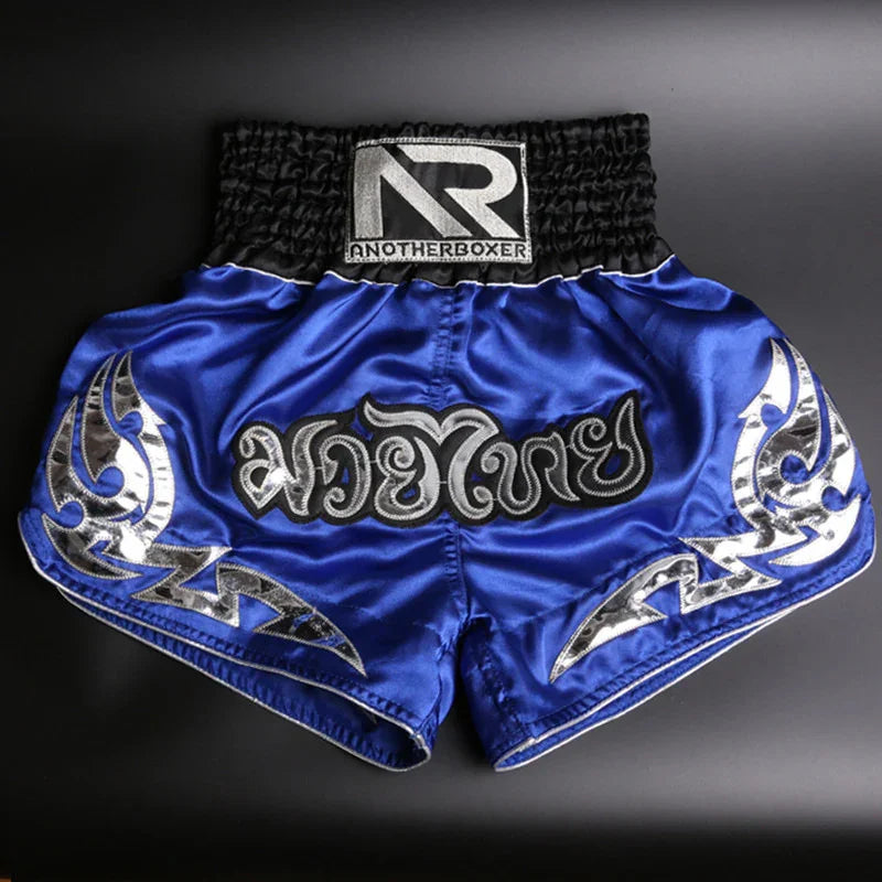 Blue Muay Thai shorts with silver tribal patterns and AnotherBoxer logo on waistband