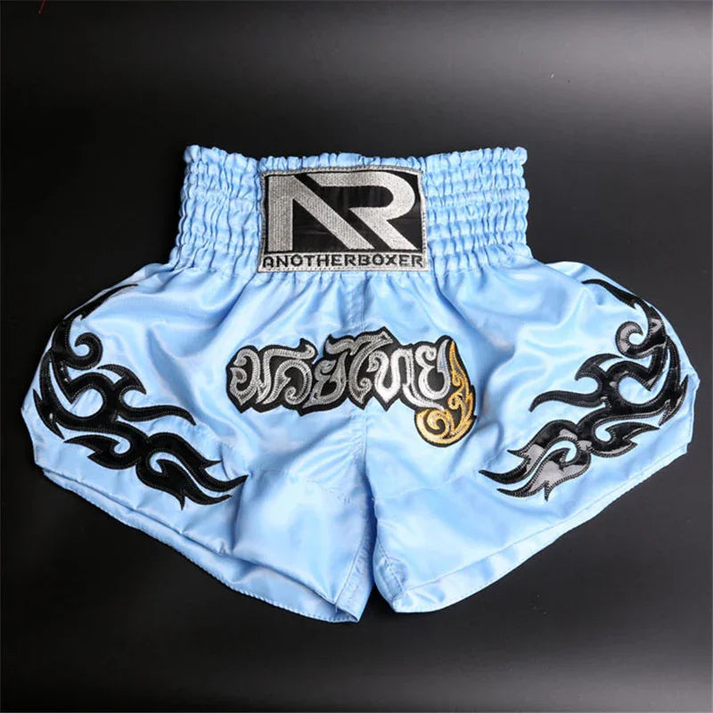 Light blue Muay Thai boxing shorts with black tribal designs and AnotherBoxer logo
